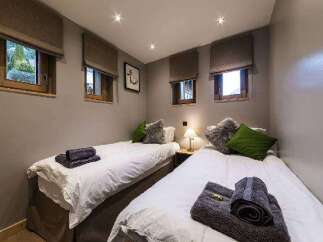 This cozy bedroom features two twin beds, perfect for guests or family.