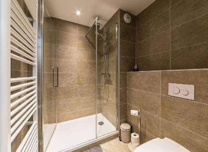 Step into a modern bathroom with a sleek glass shower enclosure.