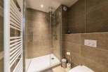 Step into a modern bathroom with a sleek glass shower enclosure.