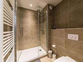 Step into a modern bathroom with a sleek glass shower enclosure.