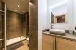 This modern bathroom features a sleek shower with glass doors and a stylish vanity.