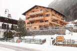 Discover the charm of this stunning wooden chalet nestled in a snowy mountain landscape.