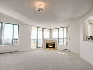 Experience luxury living in this stunning property, featuring a cozy fireplace and expansive windows that flood the space with natural light.