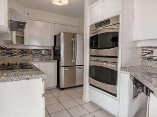This stunning kitchen boasts modern appliances and sleek design.