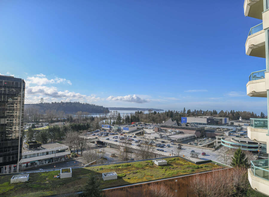 Enjoy stunning views from this modern condo, overlooking a vibrant cityscape and the serene waters.