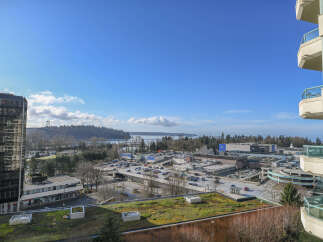 Enjoy stunning views from this modern condo, overlooking a vibrant cityscape and the serene waters.