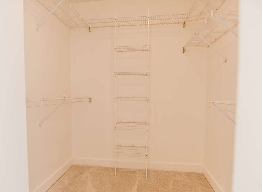 Step into this spacious walk-in closet, offering ample storage and organization.