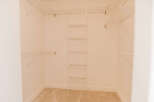 Step into this spacious walk-in closet, offering ample storage and organization.