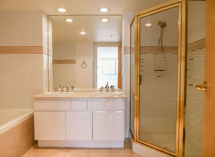 Step into a luxurious bathroom featuring a double vanity with ample counter space.