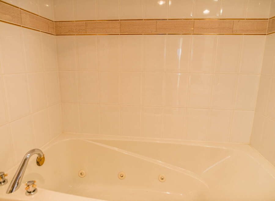 This luxurious bathroom features a spacious jacuzzi tub, perfect for relaxing after a long day.