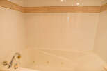 This luxurious bathroom features a spacious jacuzzi tub, perfect for relaxing after a long day.