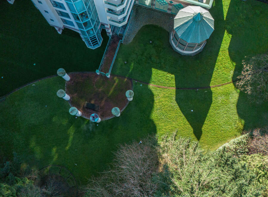 An aerial view showcases a unique property featuring a distinctive architectural design.