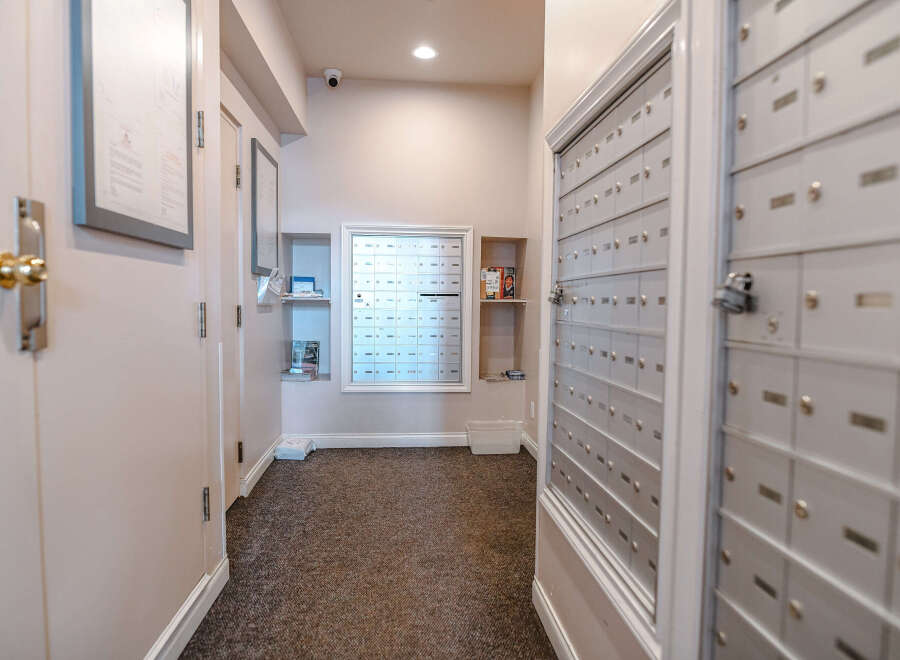 This image showcases a well-maintained apartment hallway, featuring a bank of mailboxes for residents' convenience.