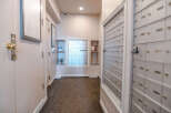 This image showcases a well-maintained apartment hallway, featuring a bank of mailboxes for residents' convenience.
