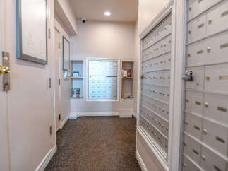 This image showcases a well-maintained apartment hallway, featuring a bank of mailboxes for residents' convenience.