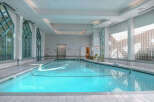 This stunning indoor pool offers a serene and inviting atmosphere, perfect for relaxation and exercise.