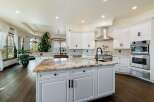 This stunning kitchen boasts a luxurious island with a beautiful marble countertop, perfect for meal preparation and entertaining.