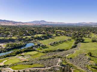 Experience luxury living with this stunning aerial view of a meticulously maintained golf course community.
