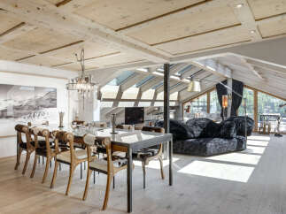 Experience luxury living in this stunning property featuring a modern dining area with a glass table and stylish cowhide chairs.