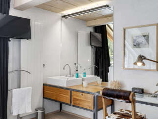 This stunning bathroom features a modern design with a touch of rustic charm.