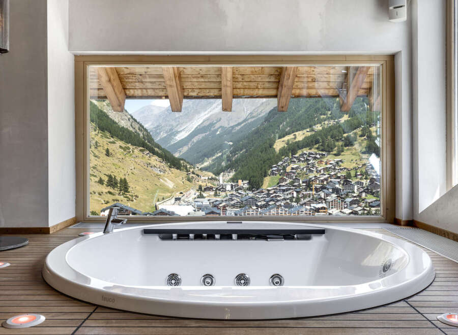 Indulge in luxury with this stunning property featuring a modern, oval-shaped bathtub.