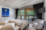 Experience luxury living in this stunning bedroom with breathtaking mountain views.