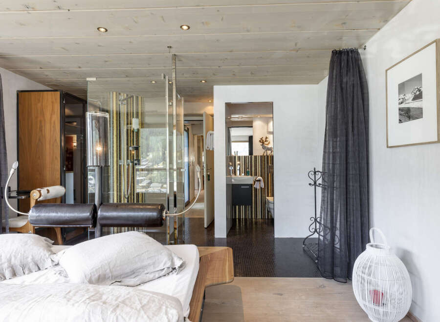 Experience luxury living in this stunning property, featuring a modern bedroom with a spa-like bathroom.