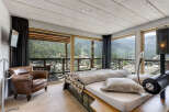 Experience luxury living in this stunning bedroom with breathtaking mountain views.