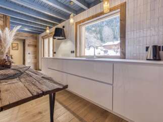 This stunning kitchen boasts a rustic charm with its wooden accents and modern amenities.
