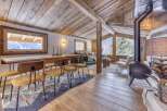 Experience rustic elegance in this stunning chalet, featuring exposed wooden beams and a cozy fireplace.