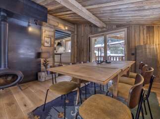 This stunning property boasts a rustic dining area, perfect for cozy gatherings.