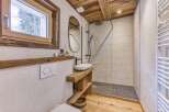 This stunning bathroom features a rustic design with wooden accents and a modern touch.