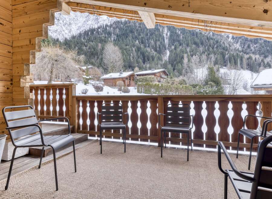 Enjoy breathtaking mountain views from this cozy balcony.