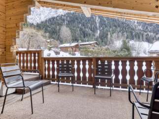 Enjoy breathtaking mountain views from this cozy balcony.