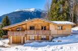 Discover the charm of this stunning wooden chalet nestled in a winter wonderland.