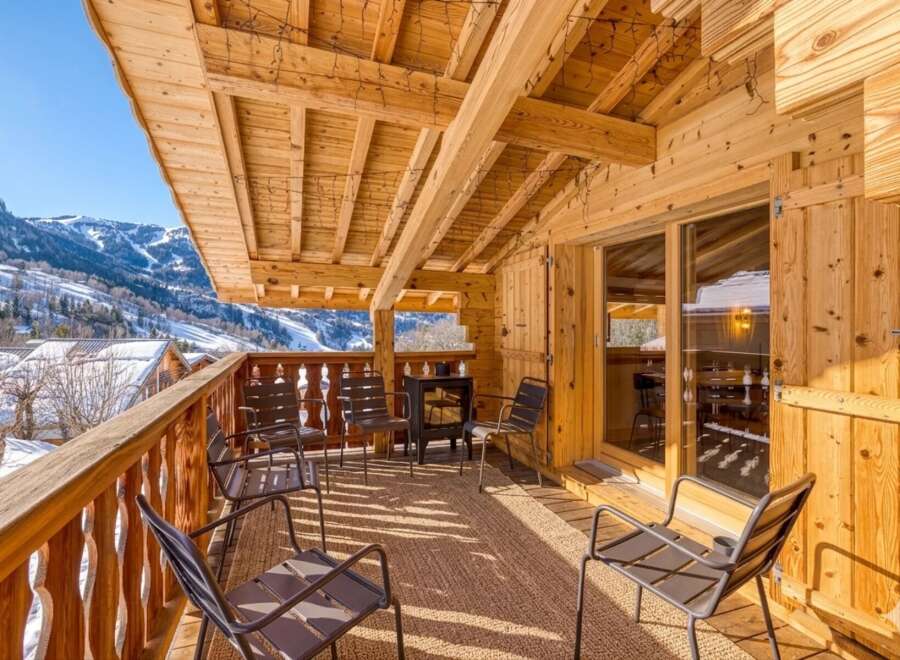 Enjoy breathtaking mountain views from this charming chalet balcony.