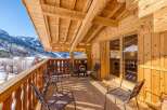 Enjoy breathtaking mountain views from this charming chalet balcony.