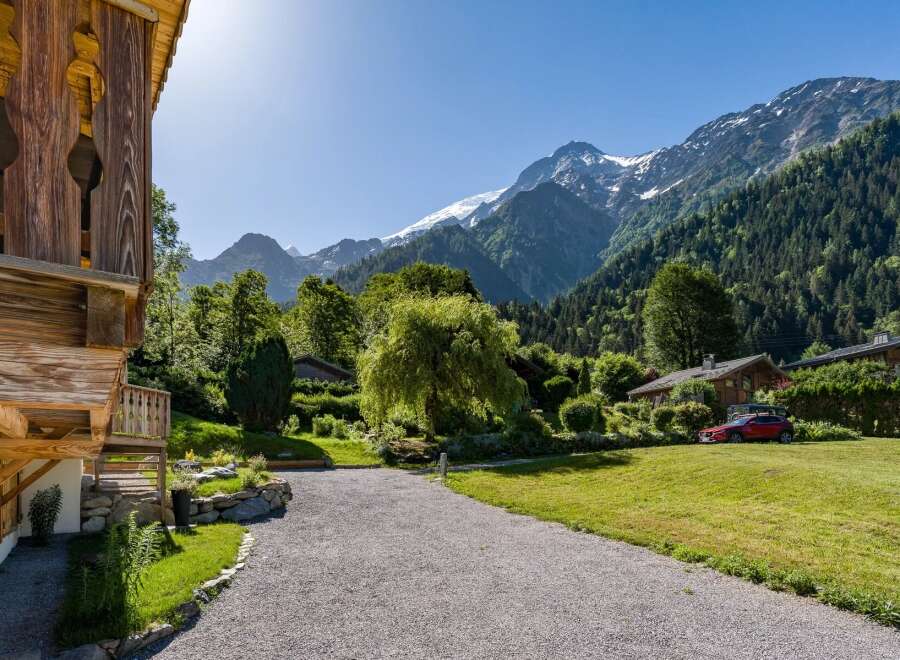 Experience the charm of alpine living in this picturesque property nestled against a backdrop of majestic snow-capped mountains.