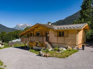 Experience alpine living in this charming wooden chalet, nestled amidst breathtaking mountain scenery.