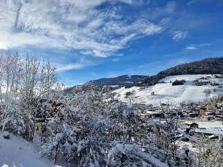 Nestled in a picturesque winter wonderland, this property offers stunning views of snow-covered mountains and a charming village.
