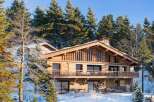 Experience the epitome of luxury living in this stunning wooden chalet nestled amidst a winter wonderland.