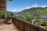 Experience breathtaking views from this stunning property, featuring a spacious wooden deck and a charming balcony.