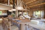 Experience rustic elegance in this stunning property, featuring a spacious open-plan living area with exposed wooden beams and a cozy fireplace.