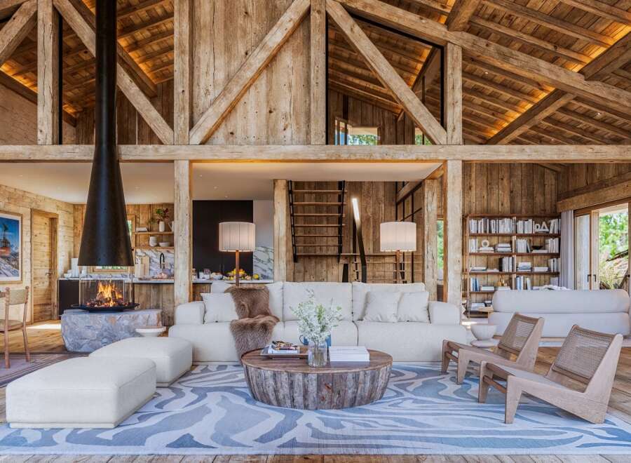 Experience rustic luxury in this stunning property, featuring exposed wooden beams and a cozy fireplace.