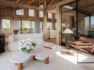 Experience luxury living in this stunning property, featuring a beautifully designed interior with exposed wooden beams and a cozy ambiance.