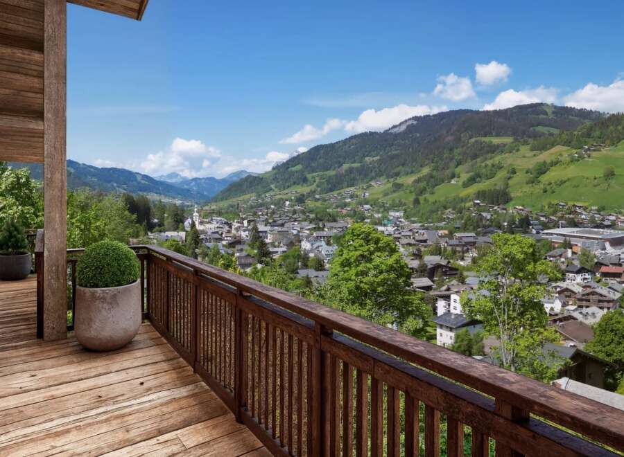 Experience breathtaking views from this stunning property, featuring a spacious wooden deck and a charming balcony.