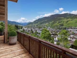 Experience breathtaking views from this stunning property, featuring a spacious wooden deck and a charming balcony.