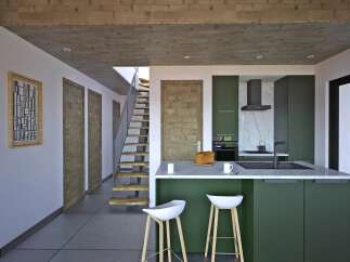 This modern kitchen boasts a sleek design with a green island and white countertops, perfect for culinary enthusiasts.