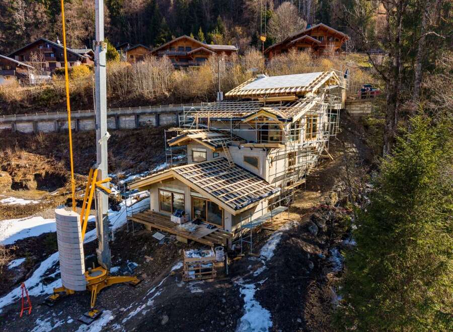 This stunning property showcases modern architecture with a focus on natural materials and expansive views.