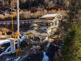 This stunning property showcases modern architecture with a focus on natural materials and expansive views.